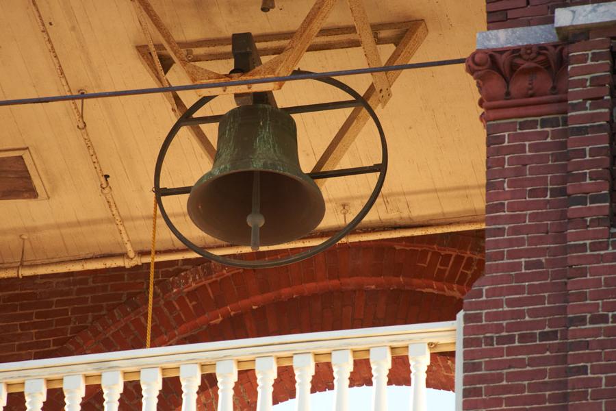 A close up of the bell ringing in the belltower.